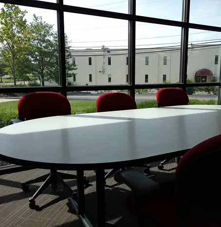 A table in a meeting room next to a window at Magnum Press in Columbus, Ohio